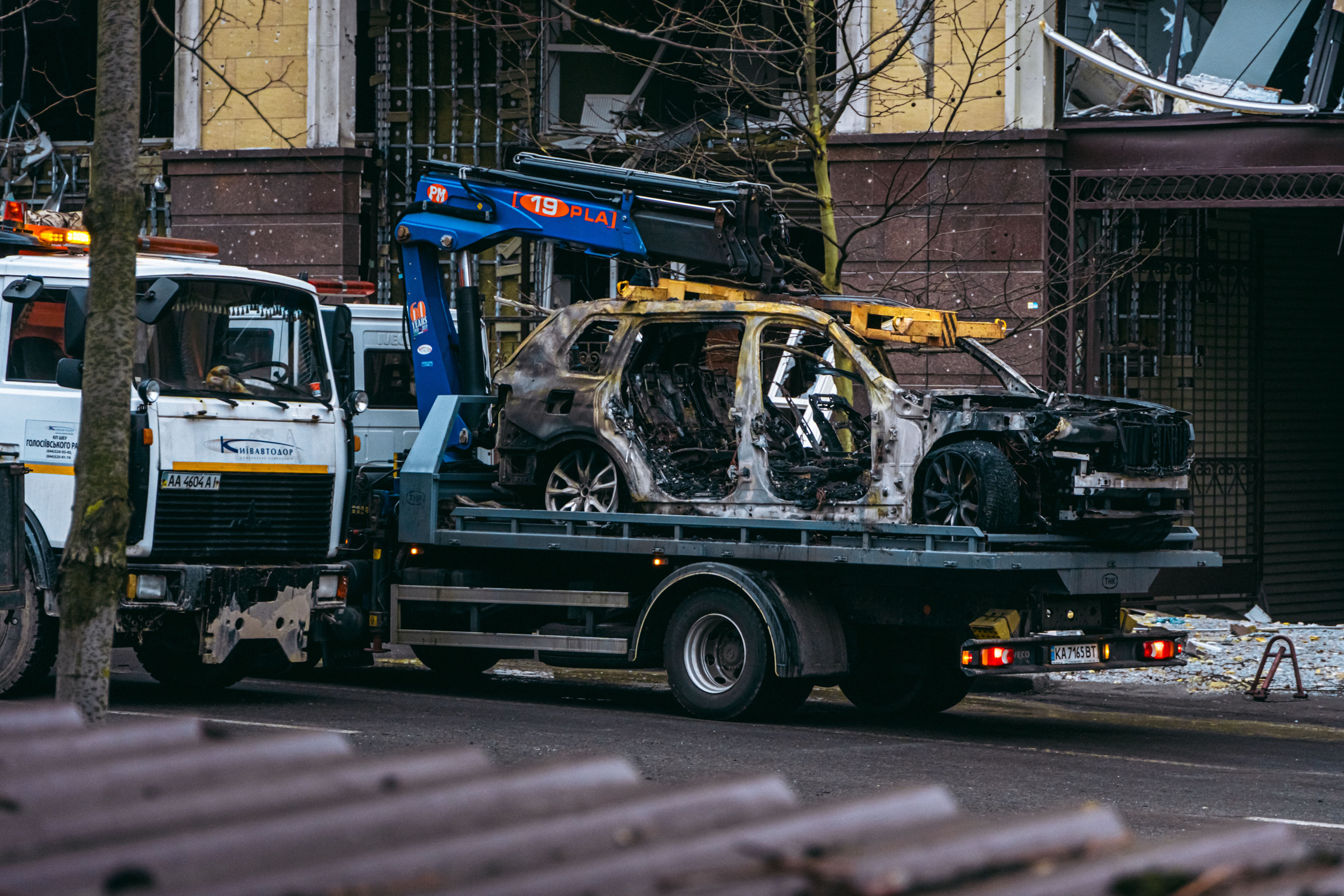 Flatbed tow truck transporting a luxury vehicle